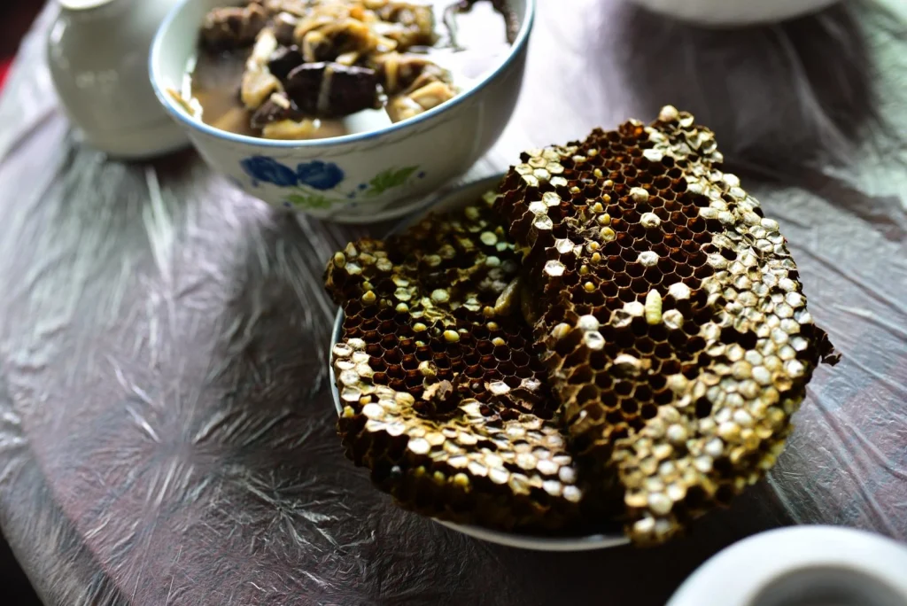 A cooked honeycomb with young bees inside