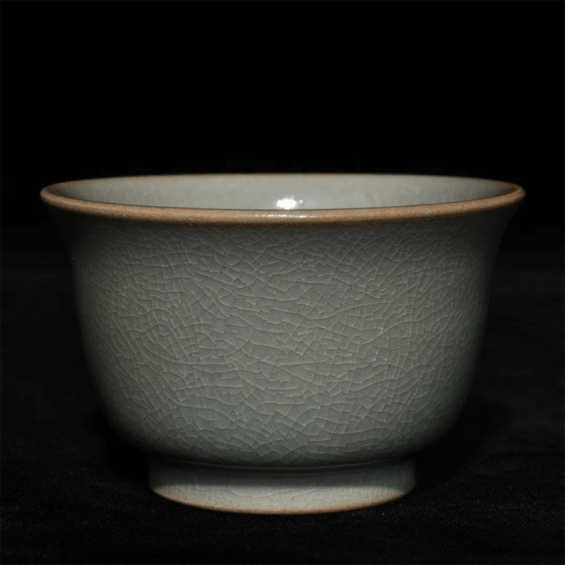 Vibrant golden Sheng Puerh tea liquor in a pale moon-white Ruyao cup, highlighting the visual contrast and crackle glaze