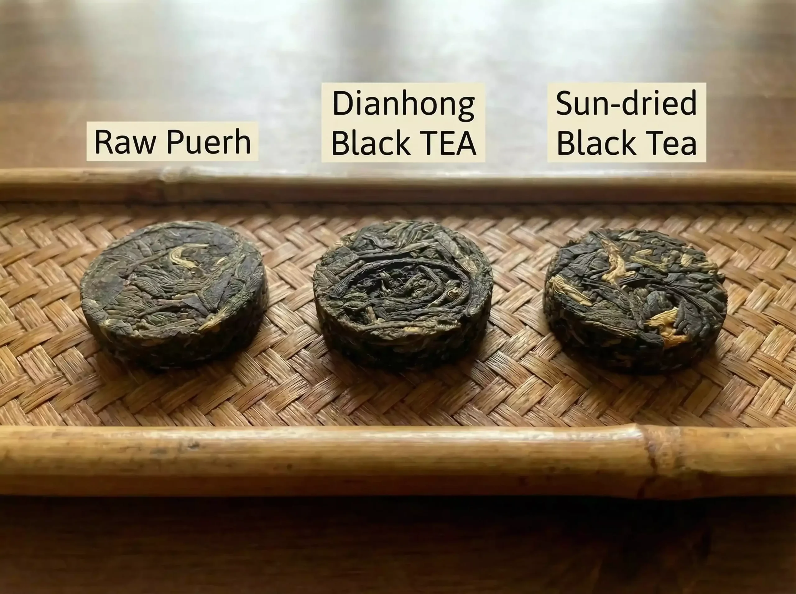 Traditional large pu-erh tea cake next to small 2g mini tea cakes – showing the contrast between complexity and simplicity