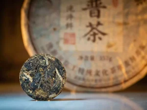 Close-up of a Micro Pu-erh Tea Disc showing compressed dried tea leaf texture and portable circular design.