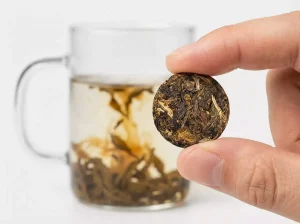 Minimalist desk setup featuring a Steeped Roots Micro Tea Cake being brewed, showcasing a mindful tea break in a modern workspace.