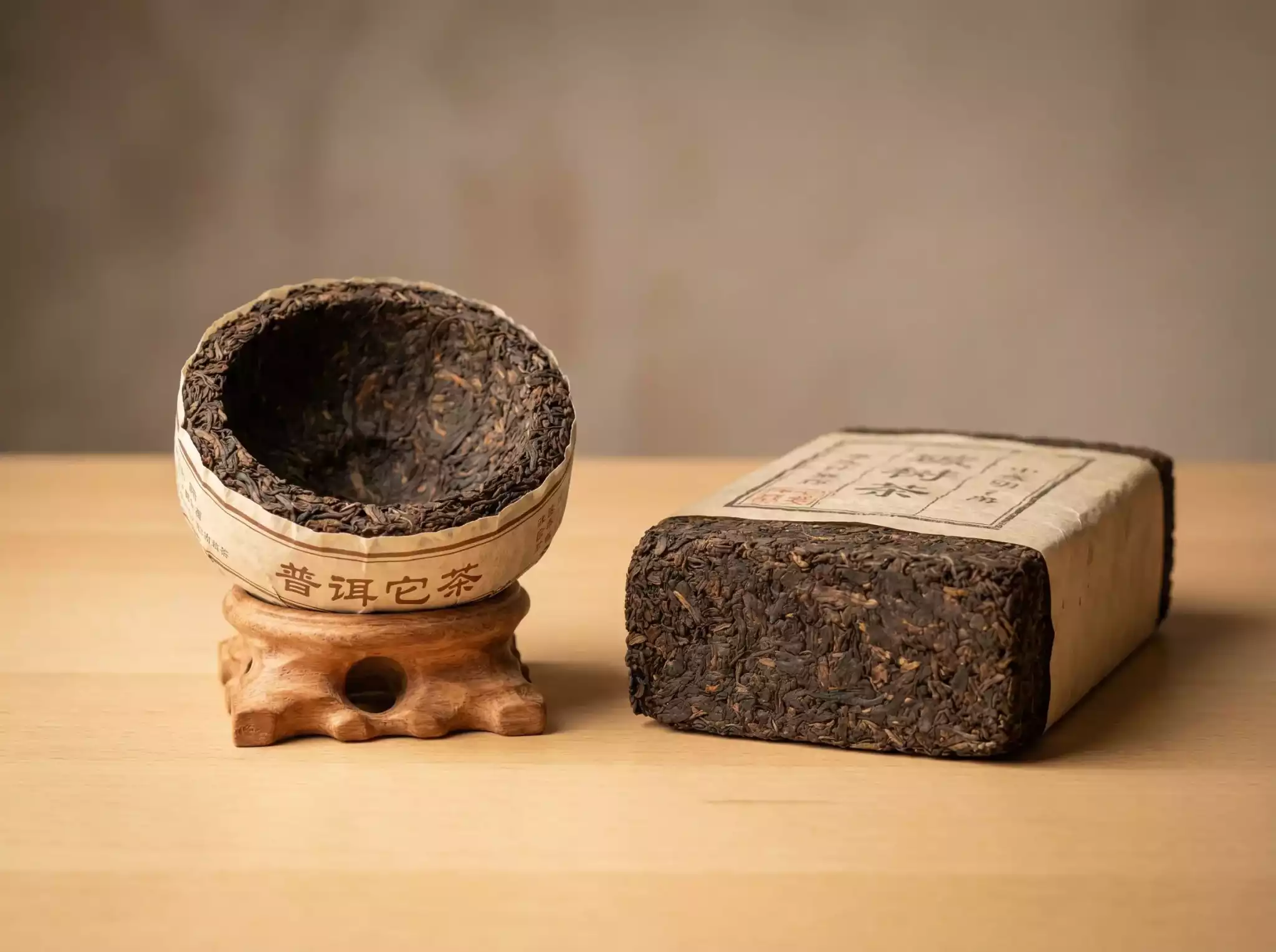A bowl-shaped Pu-erh Tuocha and a thick rectangular Brick Tea