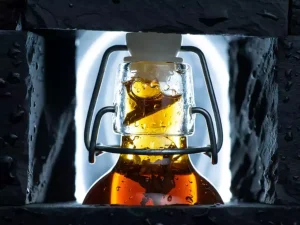 Crystalline cold brew tea in a professional minimalist swing-top glass bottle