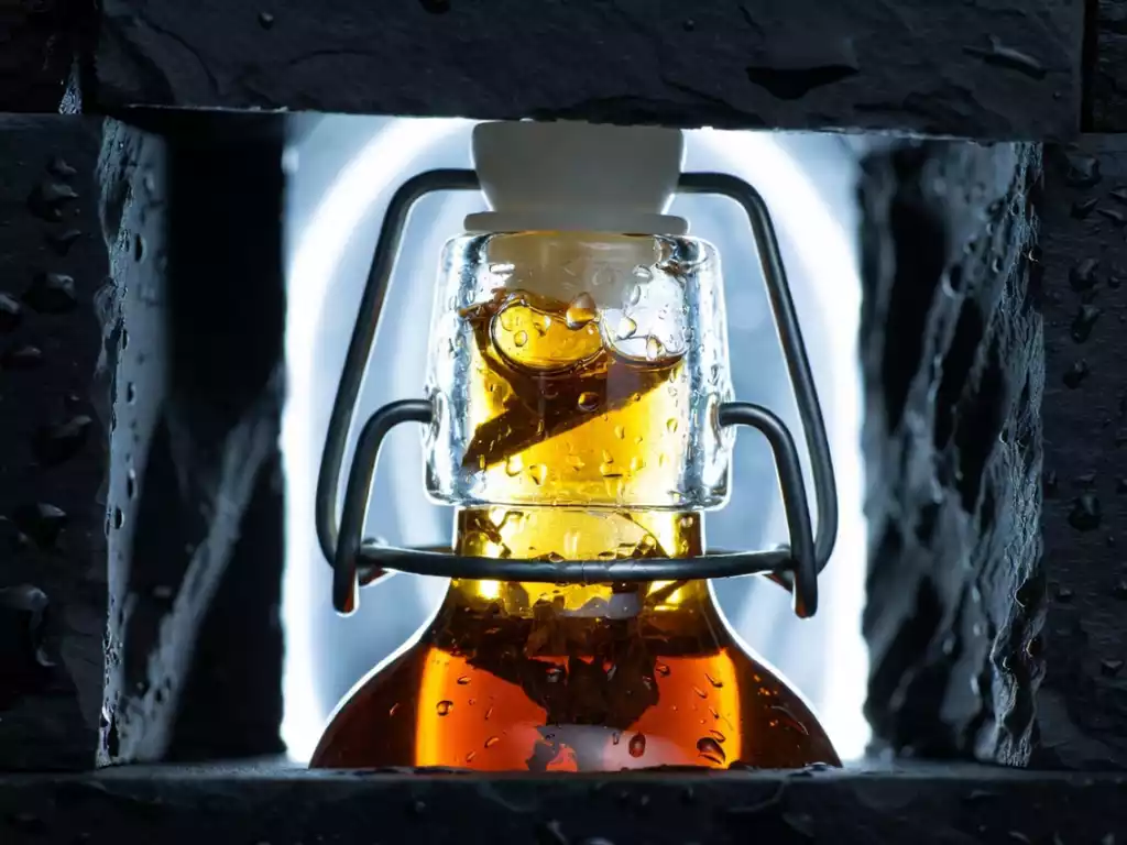 Crystalline cold brew tea in a professional minimalist swing-top glass bottle